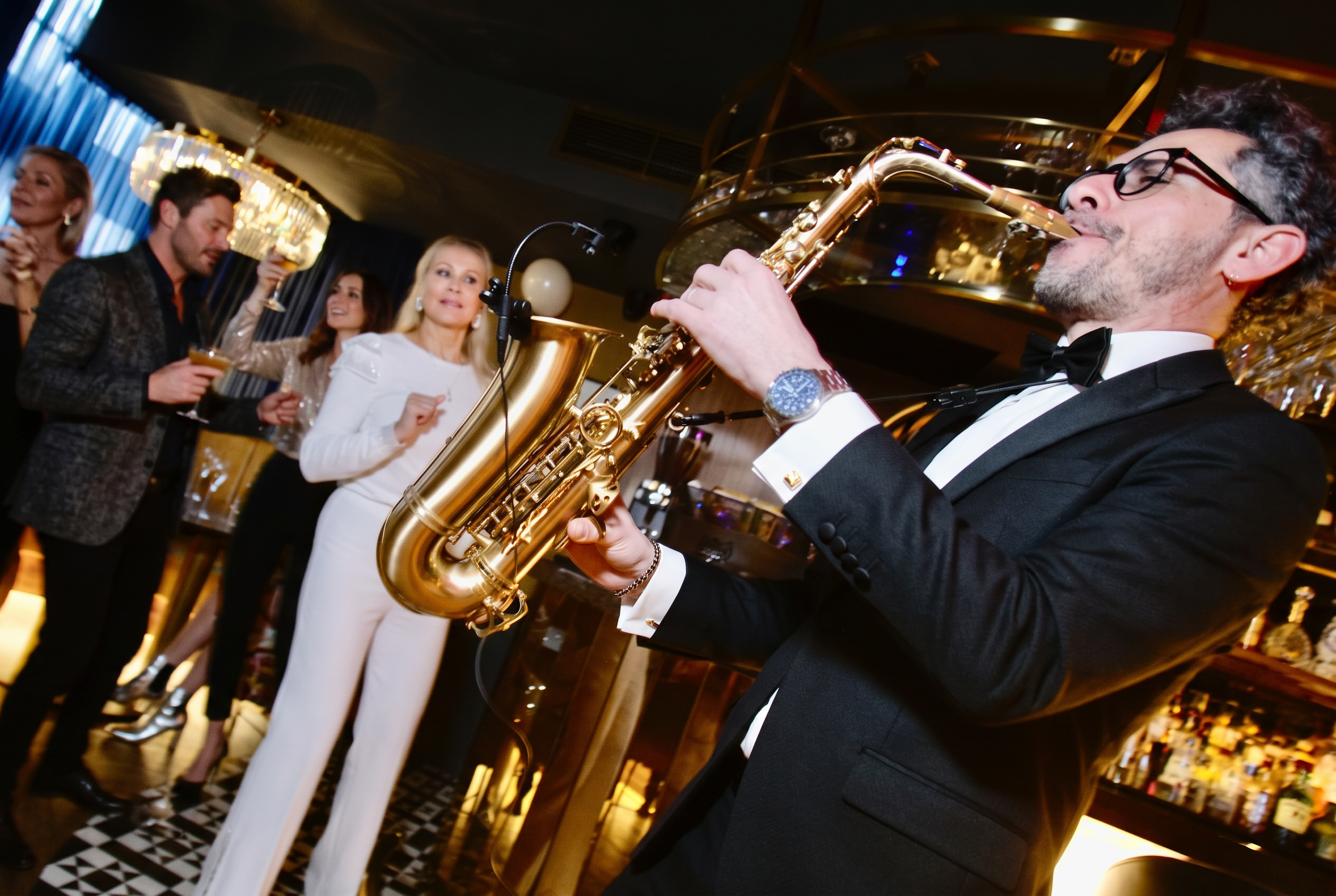Saxophonist performing live in an elegant club room